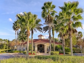 A hotel with a central entrance, surrounded by palm trees and a well-maintained garden. - Ov535 - Emerald Island - 7 Bed 4 Baths Villa (Kissimmee)