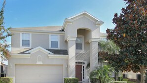A two-story house with a garage, a front porch, and a well-maintained lawn. - Ov2116 - Windsor Hills Resort - 6 Bed 4 Baths Villa (Kissimmee)