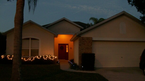 A residential house with a garage, a front door, and a small porch area. - Ov2287 - Espirit - 3 Bed 2 Baths Villa (Davenport)