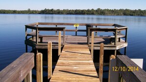 A wooden dock extending into calm water with a caution sign, surrounded by trees. - Ov2287 - Espirit - 3 Bed 2 Baths Villa (Davenport)