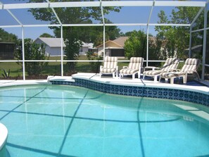 A swimming pool with a tiled edge, surrounded by a covered area with white lounge chairs. - Ovm2258 - Indian Ridge - 4 Bed 2 Baths Villa (Kissimmee)