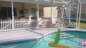 A swimming pool with a white fence, lounge chairs, and a slide. - Ov2672 - Lindfields - 4 Bed 3 Baths Villa (Kissimmee)