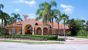 A building with a clock tower, arched windows, and a red-tiled roof. - Ov3875 - Solana - 6 Bed 5 Baths Townhome (Davenport)