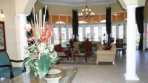 A spacious lobby with a round table, a sofa, and a large vase of flowers. - Ov3875 - Solana - 6 Bed 5 Baths Townhome (Davenport)