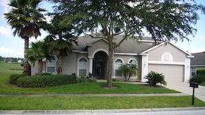 A single-story house with a front entrance, a garage, and a well-maintained lawn. - Ov4075 - Highlands Reserve - 4 Bed 3 Baths Villa (Davenport)