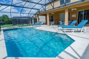A swimming pool with lounge chairs, a covered patio area, and a clear view of the surrounding landscape. - Ovm648 - Emerald Island - 7 Bed 4 Baths Villa (Kissimmee)