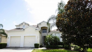 A two-story house with a garage, a covered entryway, and a well-maintained lawn. - Ov4195 - Windsor Hills Resort - 5 Bed 5 Baths Villa (Kissimmee)