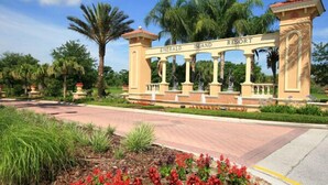 Entrada de un resort con un letrero que dice "Emerald Island Resort" y un camino que lleva a la entrada.