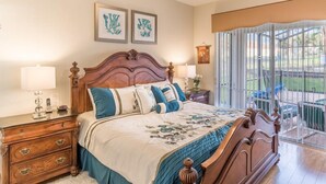 A bedroom with a wooden bed, two bedside tables with lamps, a dresser, and a large window with a view of the outdoors. - Ov4009 - Windsor Hills Resort - 4 Bed 4 Baths Villa (Kissimmee)
