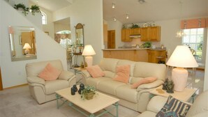 A living room with a sofa set, a coffee table, and a lamp. There is a staircase leading to another level. - Ov64 - Oak Island Harbour - 3 Bed 2.5 Baths Villa (Kissimmee)