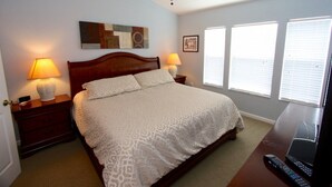 A bedroom with a bed, two bedside tables with lamps, a ceiling fan, and a window with blinds. - Ov4200 - Windsor Hills Resort - 3 Bed 3 Baths Villa (Kissimmee)