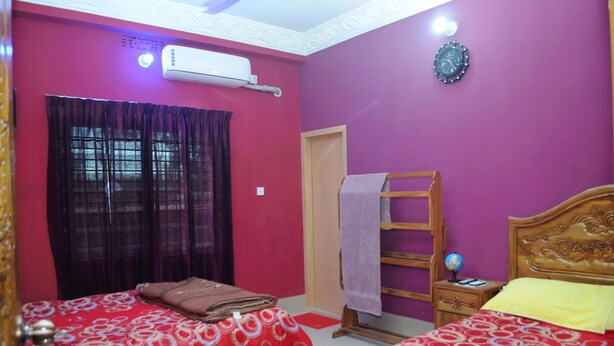 A room with two beds, a wooden ladder, a globe, and an air conditioning unit. - Tamim Resort (Sreemangal)