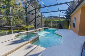 A swimming pool with a glass enclosure, surrounded by a concrete deck and a house. - Ev85594 - The Sanctuary at West Haven - 4 Bed 3 Baths Villa (Davenport)