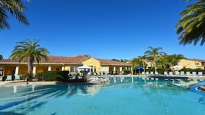 A pool area with clear blue water, lounge chairs, and palm trees. - Fs55568 - Oakwater Resort - 2 Bed 2 Baths Townhome (Kissimmee)