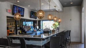 A bar area with a counter, bar stools, and hanging pendant lights. - Fd88884 - Windsor At Westside Resort - 5 Bed 4.5 Baths Townhouse (Kissimmee)