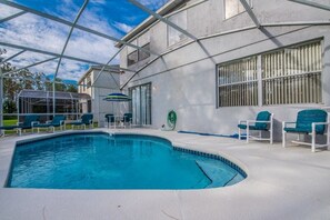 A swimming pool with a covered area, lounge chairs, and a hose reel. - Ev54115 - Highlands Reserve - 5 Bed 3 Baths Villa (Davenport)