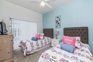 A bedroom with two beds, a ceiling fan, a nightstand, and a dresser. - Ev215108 - The Abbey at West Haven - 4 Bed 3 Baths Villa (Davenport)
