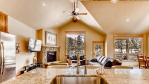 A kitchen with granite countertops, a stainless steel sink, and a ceiling fan. - River Run Townhome RR84 - RVJR by RedAwning (Keystone)