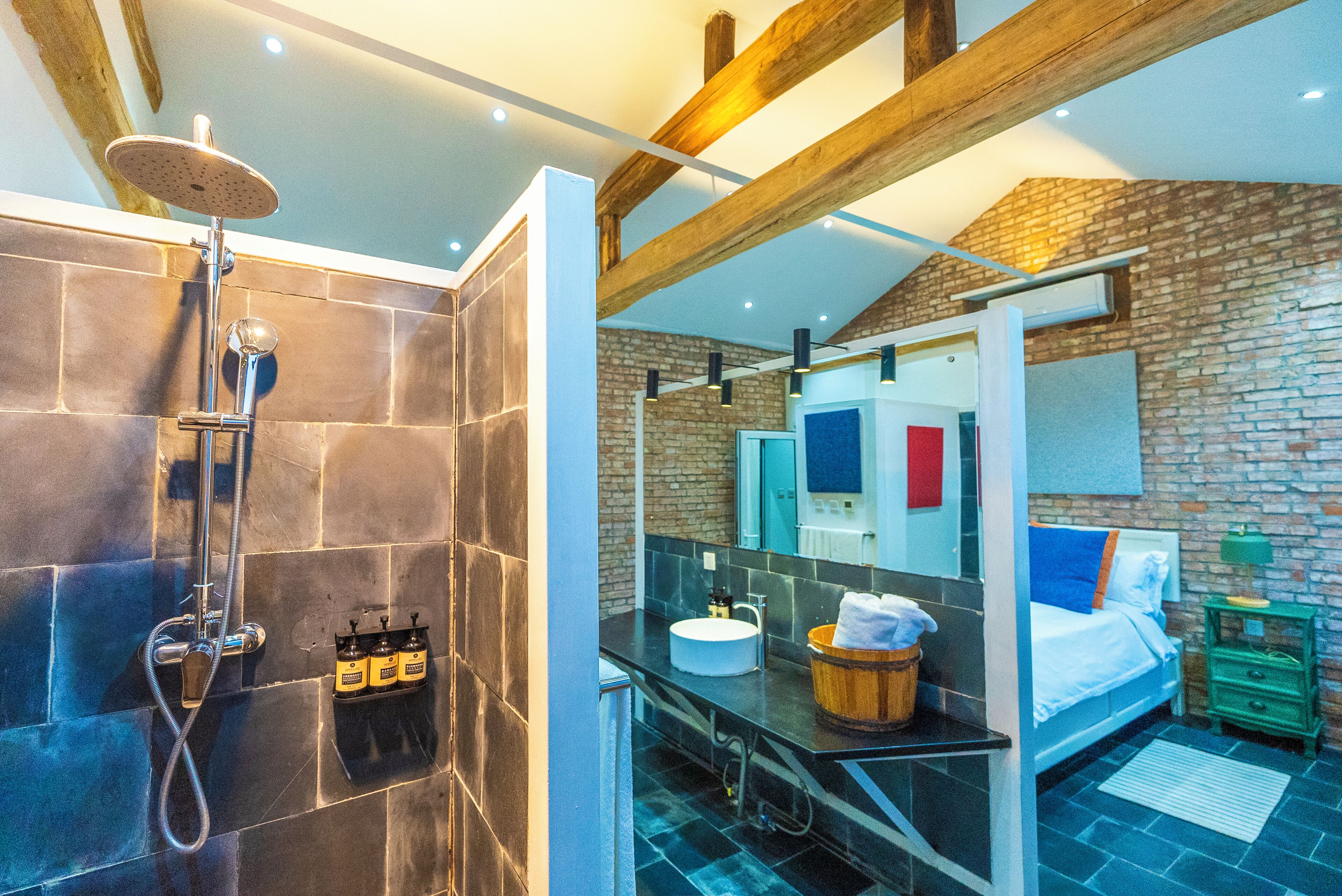 A modern bathroom with a shower, a sink, and a mirror.