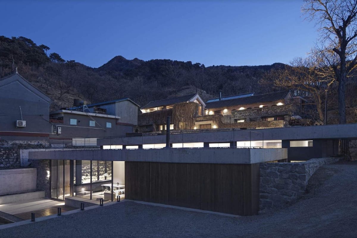 A modern building with a glass entrance and a stone facade.