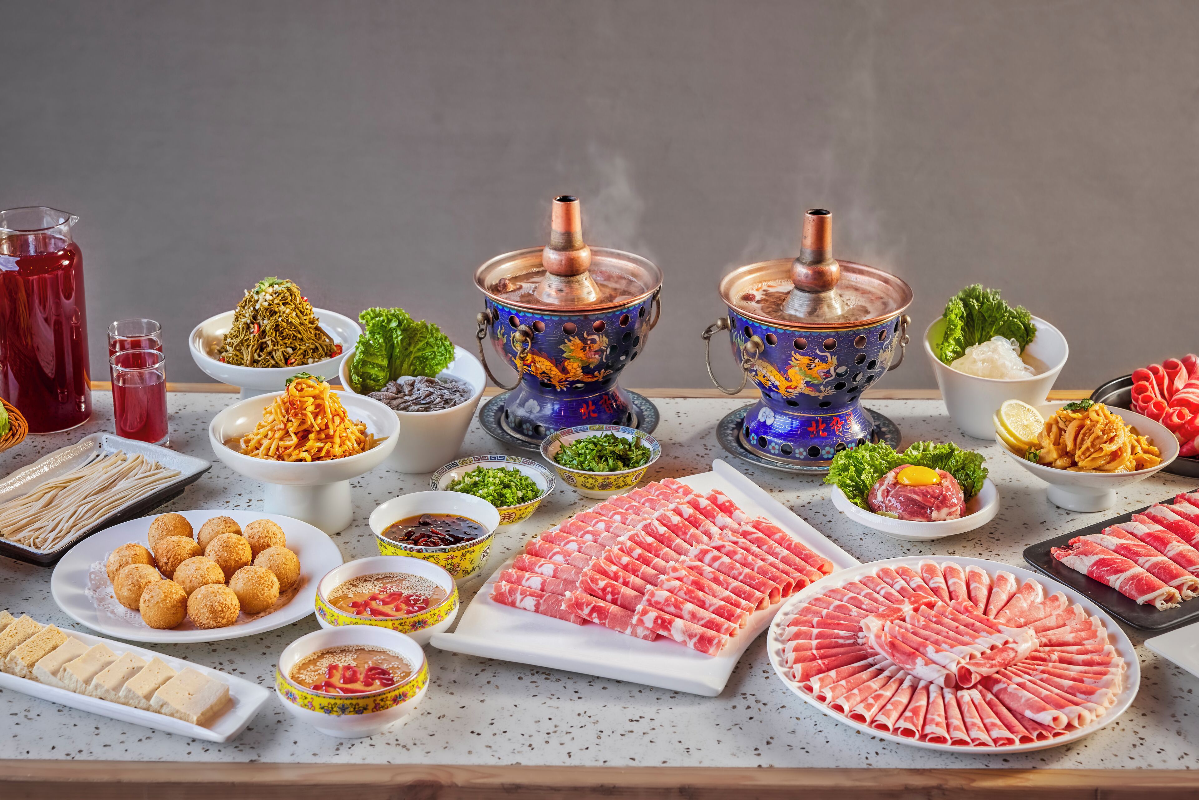 A variety of food items and cooking equipment on a table.