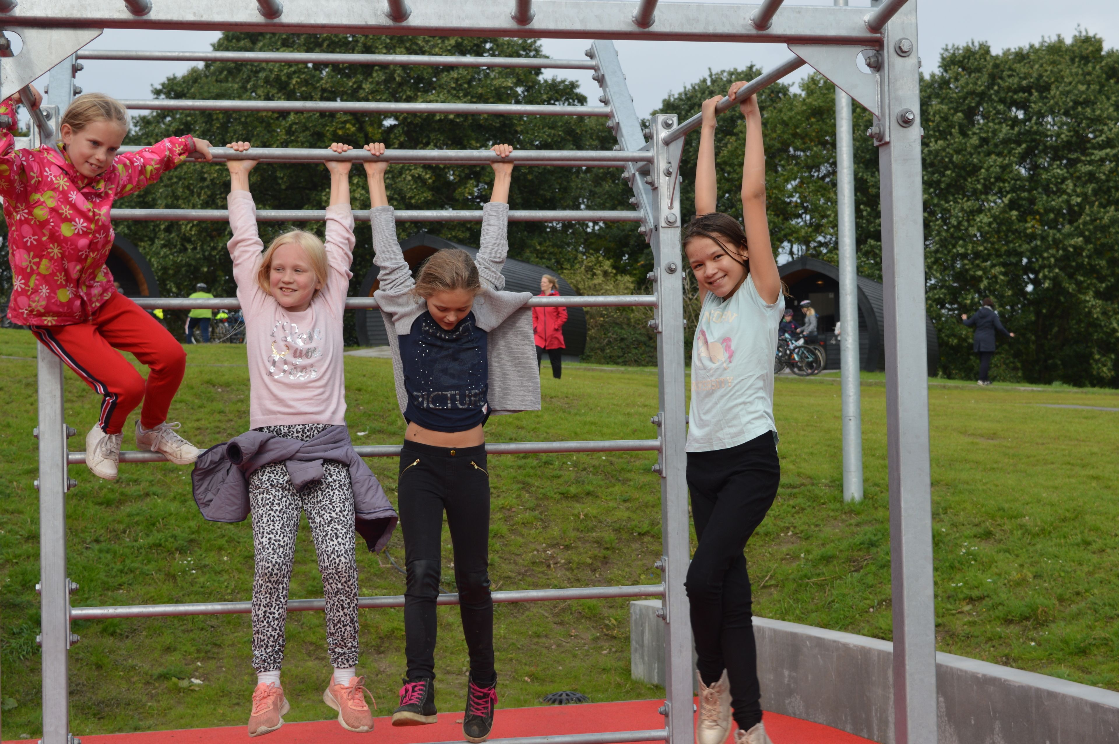 A playground with metal bars and a red platform.