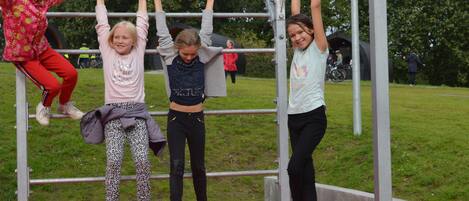 A playground with metal bars and a red platform.
