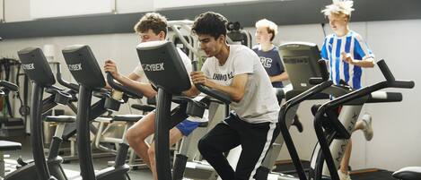 A gym with multiple treadmills and exercise equipment.