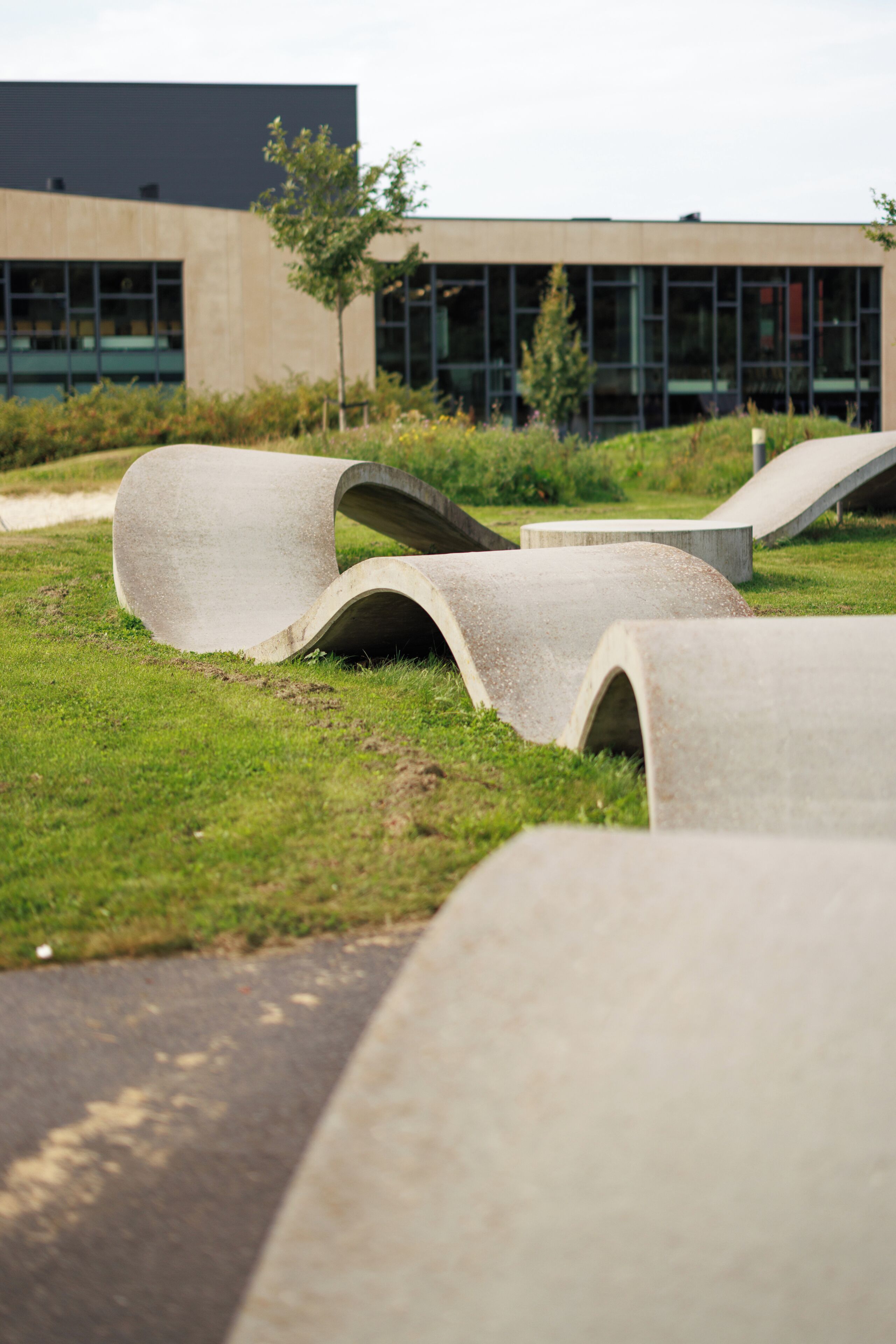 Concrete structures in an outdoor setting with a modern building in the background.