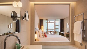 A modern hotel bathroom with a large mirror, a bathtub, and a sink. - Waldhotel by Bürgenstock Lake Lucerne (Ennetbuergen)