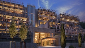 A modern hotel with a multi-story structure, large windows, and a well-lit entrance. - Waldhotel by Bürgenstock Lake Lucerne (Ennetbuergen)