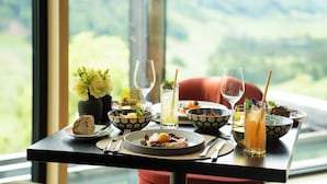 A dining table with various dishes, glasses, and a vase of flowers. - Waldhotel by Bürgenstock Lake Lucerne (Ennetbuergen)