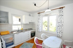 Fridge, stovetop, electric kettle, cookware/dishes/utensils
