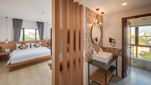 A hotel room with a bed, bedside table, and a bathroom with a sink and mirror. - Phnom Penh 51 Hotel & Residences (Phnom Penh)