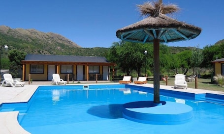 Seasonal outdoor pool, open 10 AM to 8 PM, pool loungers. Estacion Potrero Cabañas y Habitaciones