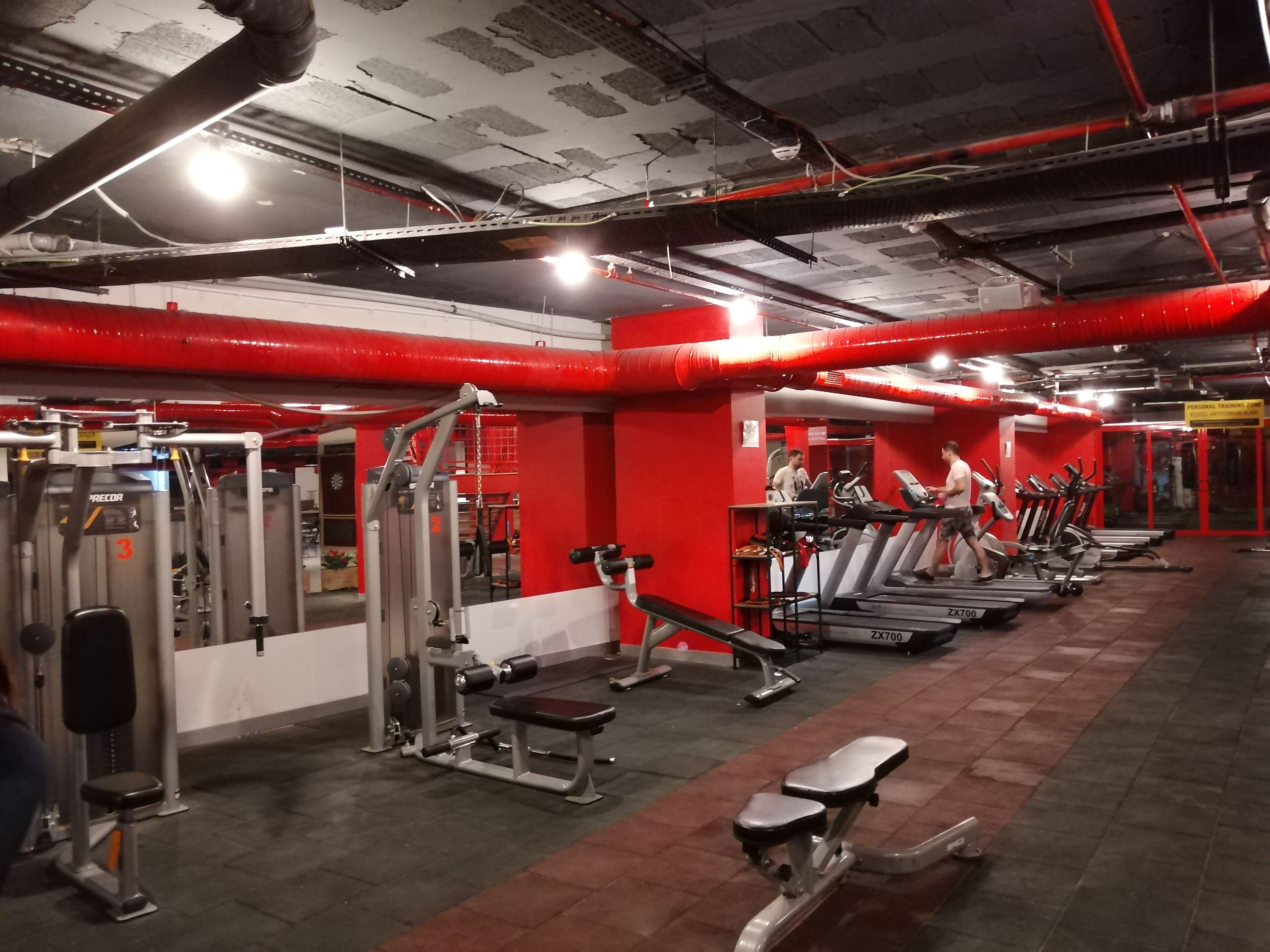 A gym with various exercise equipment, treadmills, and weight machines.