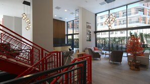 A modern interior with a red staircase, large windows, and contemporary furniture. - Coordinat Suits (Izmir)