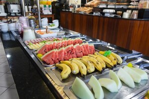 A buffet with various fruits and beverages. - HANNA San Diego Apart Hotel (Florianópolis)