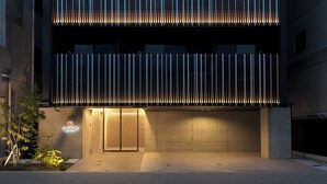 A modern building with a prominent 'e-stay' sign at the top. - e-stay ebisu (Osaka)