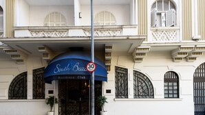 Ein Gebäude mit einem Schild, auf dem „South Beach Residence Club“ steht, und einem Geschwindigkeitslimitzeichen von 30 km/h.