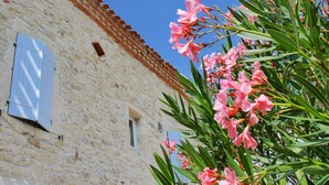A stone building with a tiled roof and a window with shutters. - La Bastide (Lamillarie)