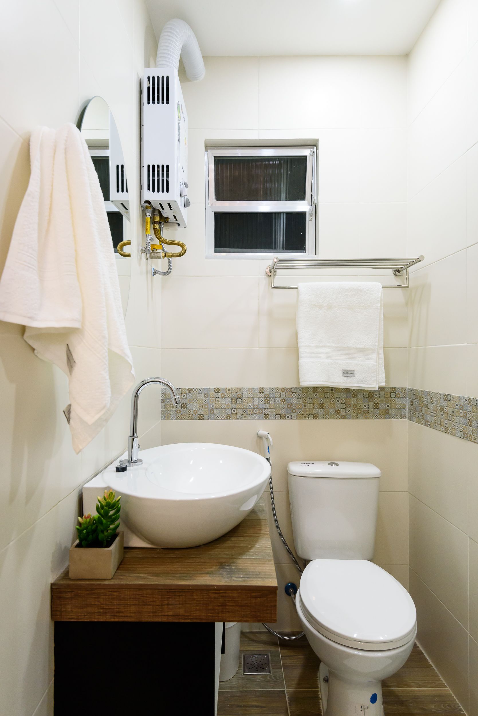 A compact bathroom with a white sink, a toilet, and a towel rack.