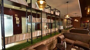 A library area with bookshelves, seating, and a coffee table.