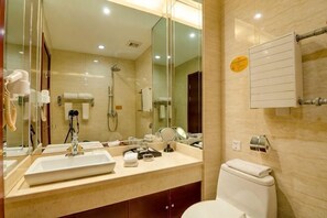 A bathroom with a sink, mirror, toilet, and towel rack. - Tianlong Hotel (Baotou)