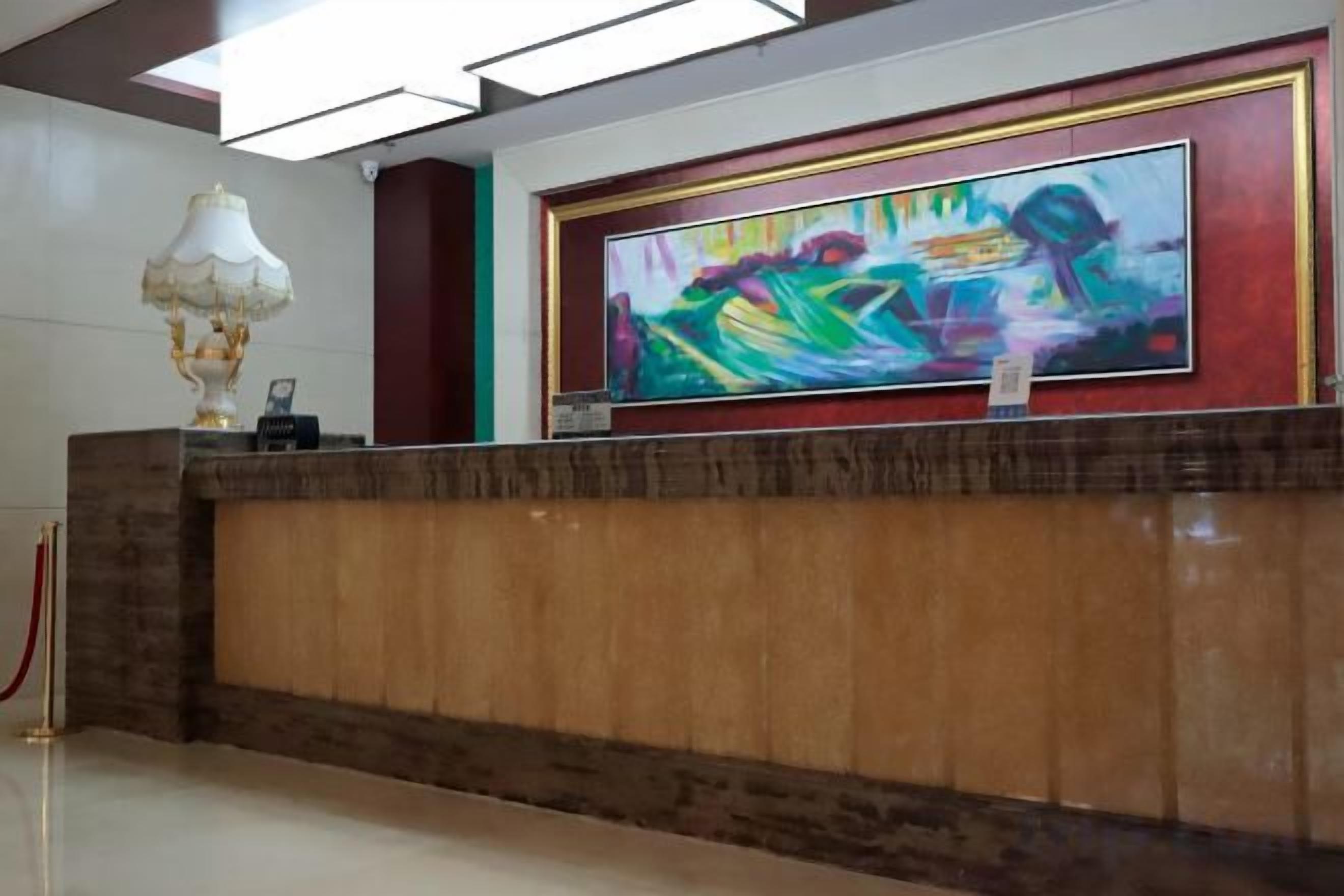 A reception desk with a framed artwork above it.