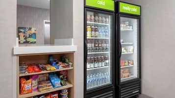A vending machine with snacks and drinks, and a refrigerator with a 'really cold' sign.