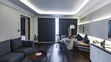 Executive suite with Executive Lounge Access & One way airport Transfer | Living area | Flat-screen TV, iPod dock