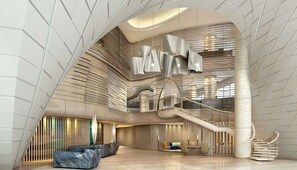 A modern interior with a curved staircase, a reception area, and a seating area with a unique design. - DoubleTree by Hilton Ahmedabad (Ahmedabad)