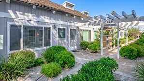 A residential house with a covered porch, a number '220' sign, and well-maintained landscaping. - Best Deal in Carpinteria! (Carpinteria)