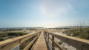 A wooden boardwalk leading to a beach with sand dunes and sparse vegetation. - Poolside 2BR Condo in Oceanfront Resort - Sleeps 6, Steps to Beach (St. Augustine)